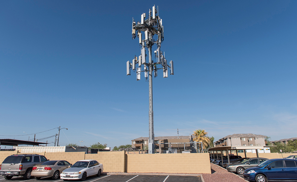Cell phone tower in city parking lot