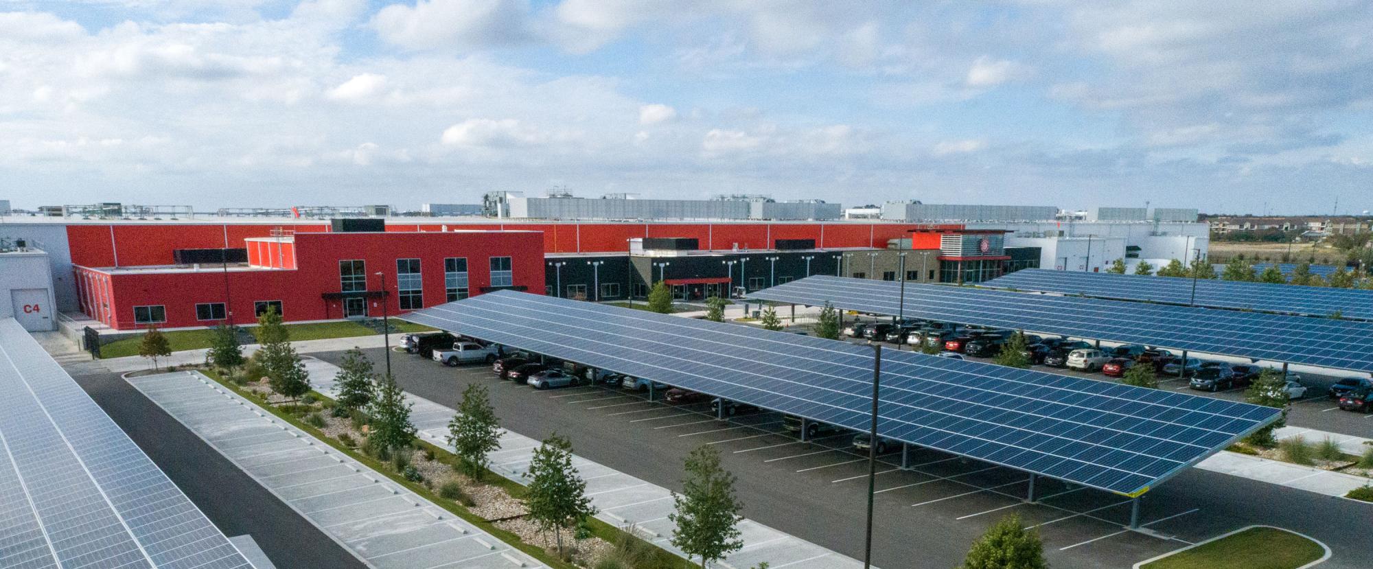 Building exterior with parking lot covered in solar panels