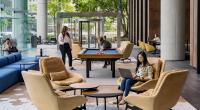 People play pool in an office lobby