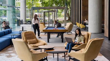 People play pool in an office lobby