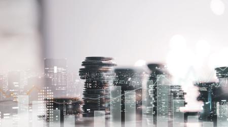 Collage image of stacks of coins and office skyline.